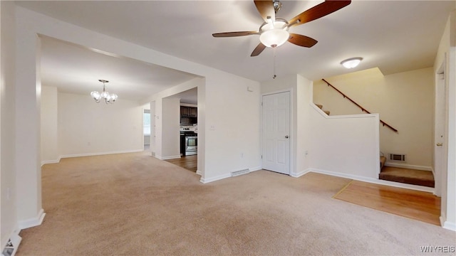 524 Lasalle Ave, Buffalo, NY 14215 - unfurnished living room featuring carpet, a chandelier, stairway, ceiling fan, and baseboards