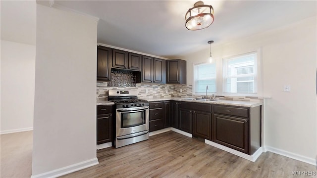 524 Lasalle Ave, Buffalo, NY 14215 - kitchen with stainless steel gas range, a sink, tasteful backsplash, and baseboards