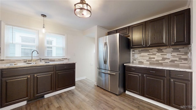 524 Lasalle Ave, Buffalo, NY 14215 - kitchen featuring freestanding refrigerator, dark brown cabinets, a sink, and tasteful backsplash