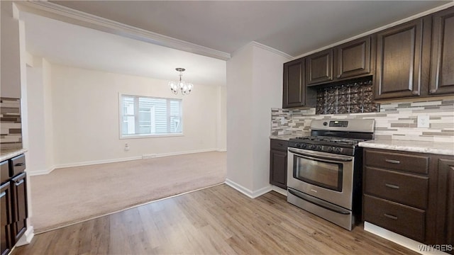 524 Lasalle Ave, Buffalo, NY 14215 - kitchen featuring stainless steel range with gas cooktop, crown molding, a chandelier, dark brown cabinets, and tasteful backsplash