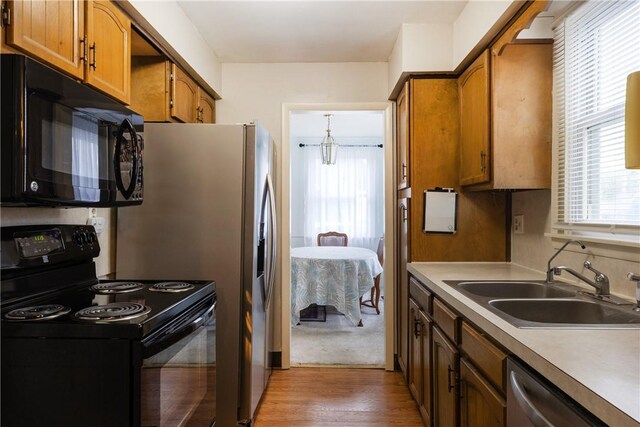 182 E Pulteney St, Corning City, NY 14830 - kitchen featuring black appliances, a sink, light wood-type flooring, brown cabinets, and light countertops