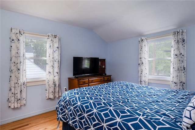 182 E Pulteney St, Corning City, NY 14830 - bedroom with vaulted ceiling, multiple windows, wood finished floors, and baseboards