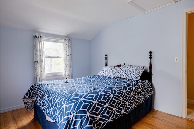182 E Pulteney St, Corning City, NY 14830 - bedroom featuring wood finished floors, vaulted ceiling, attic access, and baseboards