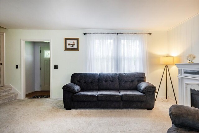 182 E Pulteney St, Corning City, NY 14830 - carpeted living area with a high end fireplace and stairway