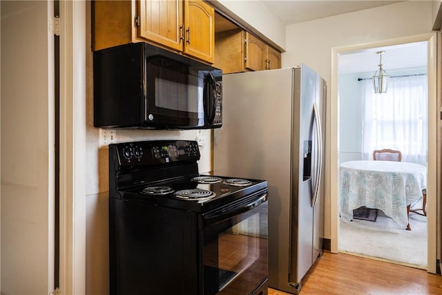 182 E Pulteney St, Corning City, NY 14830 - kitchen featuring black appliances, light wood-type flooring, and brown cabinets
