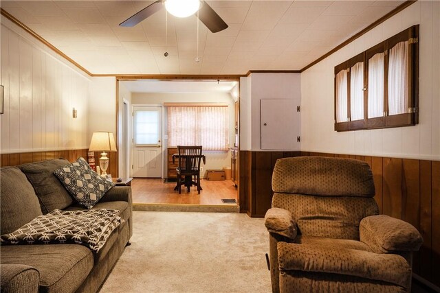 182 E Pulteney St, Corning City, NY 14830 - living room with wooden walls, ornamental molding, ceiling fan, carpet flooring, and wainscoting