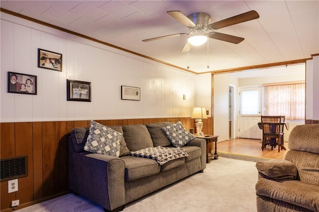 182 E Pulteney St, Corning City, NY 14830 - carpeted living area featuring crown molding, wooden walls, and a ceiling fan