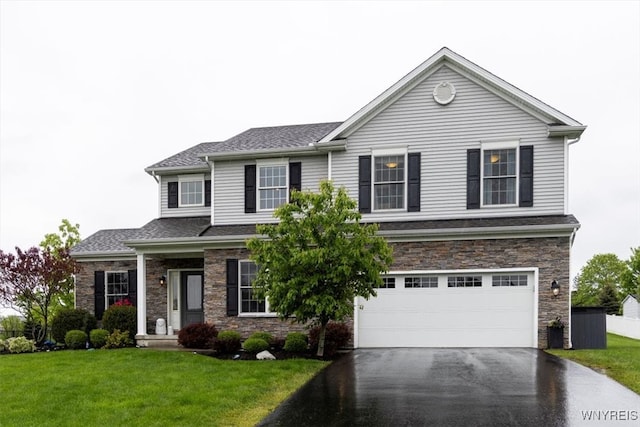 17 Knoche Way, Orchard Park, NY 14127 - view of front facade with driveway, stone siding, a garage, a front lawn, and a shingled roof