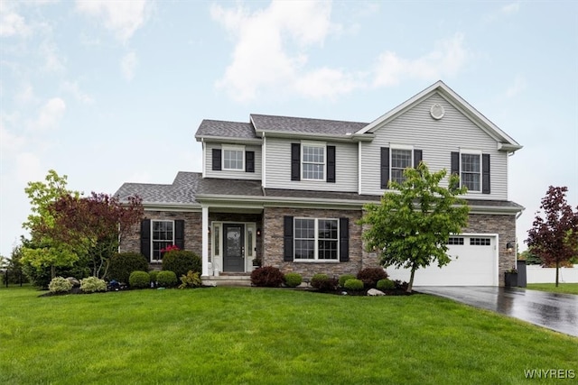 17 Knoche Way, Orchard Park, NY 14127 - view of front facade with driveway, an attached garage, stone siding, a front yard, and roof with shingles
