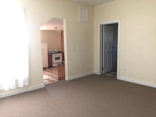 372 Diven Ave, Elmira-City, NY 14901 - spare room featuring light colored carpet, arched walkways, and baseboards