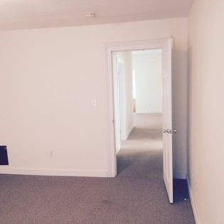 372 Diven Ave, Elmira-City, NY 14901 - corridor featuring dark colored carpet and baseboards