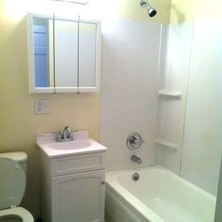 372 Diven Ave, Elmira-City, NY 14901 - bathroom with vanity, toilet, and bathtub / shower combination