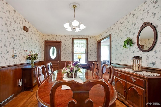 7263 Quaker Rd, Orchard Park, NY 14127 - dining space with wainscoting, light wood-style flooring, wallpapered walls, and a chandelier