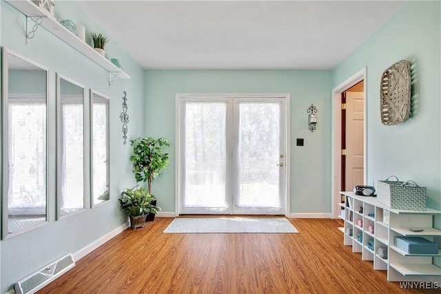 7263 Quaker Rd, Orchard Park, NY 14127 - doorway to outside with wood finished floors and baseboards