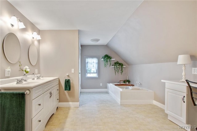 7263 Quaker Rd, Orchard Park, NY 14127 - full bath with double vanity, a bath, lofted ceiling, and baseboards