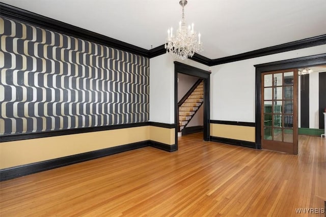 2884 Main St, Buffalo, NY 14214 - empty room featuring a chandelier, crown molding, baseboards, wood finished floors, and stairs
