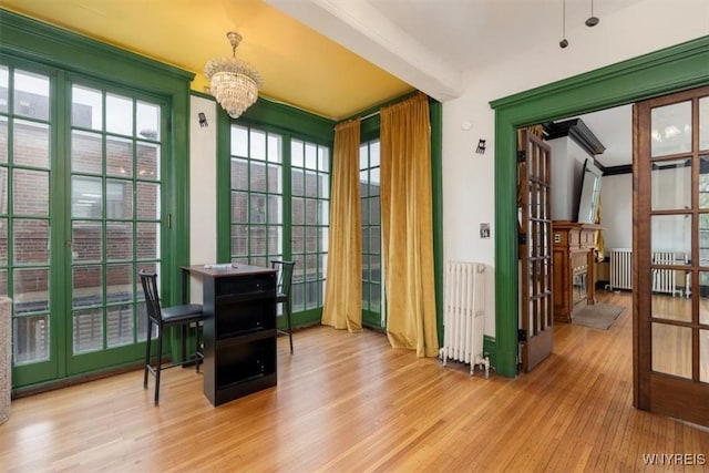 2884 Main St, Buffalo, NY 14214 - sunroom / solarium with radiator heating unit, french doors, and a chandelier