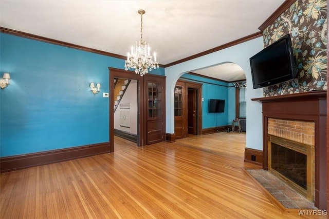 2884 Main St, Buffalo, NY 14214 - unfurnished dining area featuring a fireplace, arched walkways, wood finished floors, baseboards, and a chandelier