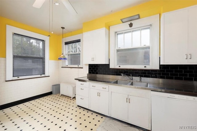 2884 Main St, Buffalo, NY 14214 - kitchen with white dishwasher, stainless steel counters, radiator, a sink, and white cabinetry