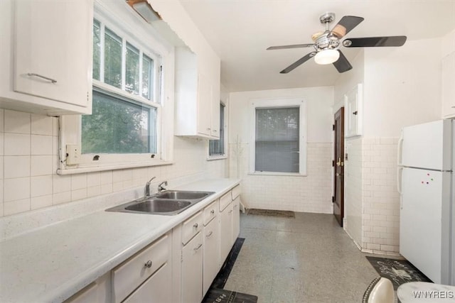 2884 Main St, Buffalo, NY 14214 - kitchen with freestanding refrigerator, a sink, light countertops, a ceiling fan, and white cabinetry