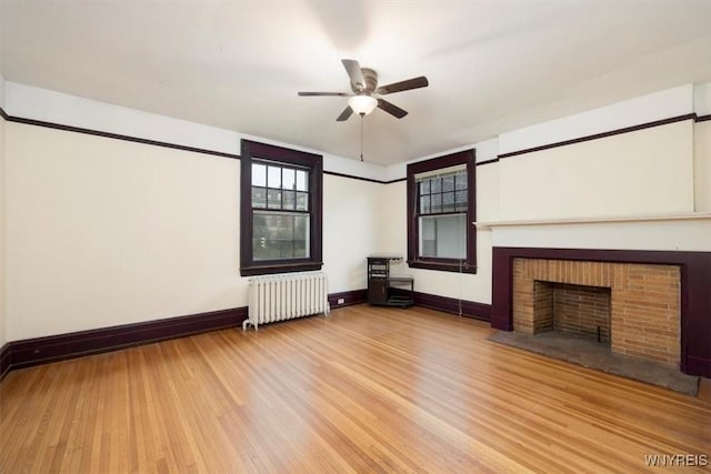 2884 Main St, Buffalo, NY 14214 - unfurnished living room featuring radiator, wood finished floors, ceiling fan, and baseboards