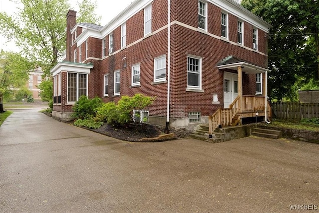 2884 Main St, Buffalo, NY 14214 - view of home's exterior with a chimney and brick siding