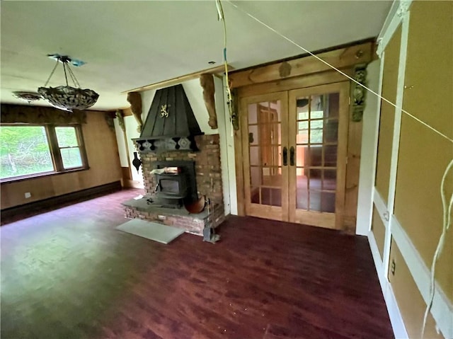 1302 Swart Rd, Middletown, NY 12455 - unfurnished living room featuring french doors, a wood stove, wood finished floors, and baseboards