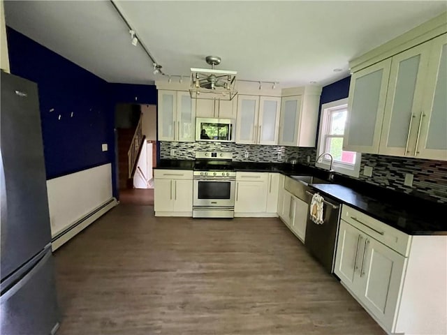 1302 Swart Rd, Middletown, NY 12455 - kitchen with appliances with stainless steel finishes, baseboard heating, a sink, dark countertops, and decorative backsplash
