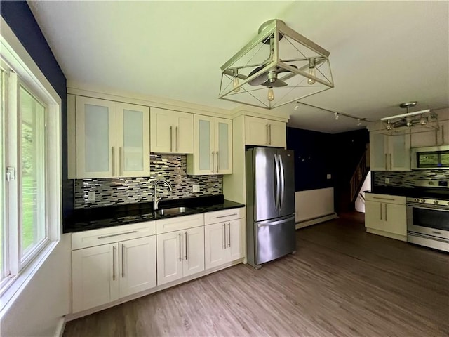 1302 Swart Rd, Middletown, NY 12455 - kitchen with appliances with stainless steel finishes, a sink, a baseboard radiator, and wood finished floors