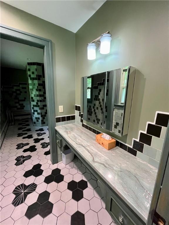 1302 Swart Rd, Middletown, NY 12455 - full bathroom with vanity, wainscoting, and tile walls