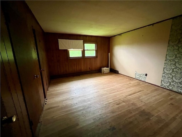1302 Swart Rd, Middletown, NY 12455 - unfurnished room with light wood-style floors, baseboards, and wooden walls
