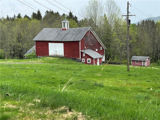 1302 Swart Rd, Middletown, NY 12455 - view of barn featuring a lawn and a wooded view