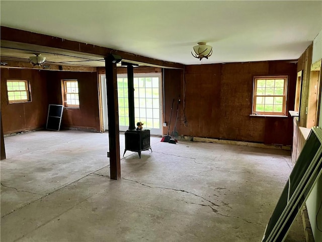 1302 Swart Rd, Middletown, NY 12455 - basement featuring a wood stove, healthy amount of natural light, and wooden walls