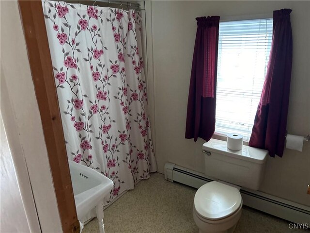 717 Lawrence St, Watertown-City, NY 13601 - bathroom with baseboard heating, toilet, and curtained shower