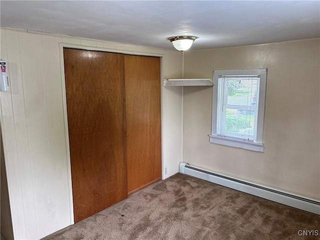 717 Lawrence St, Watertown-City, NY 13601 - unfurnished bedroom featuring baseboard heating, carpet floors, and a closet