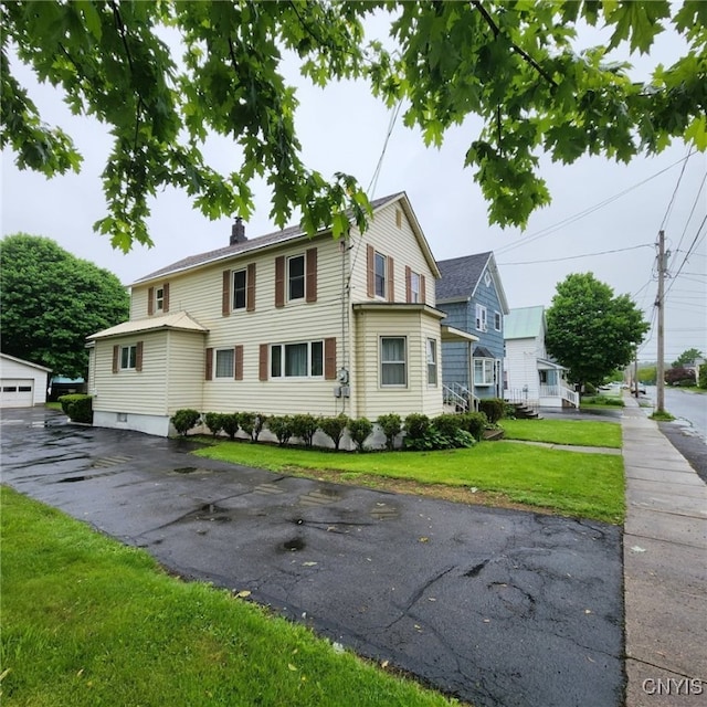 717 Lawrence St, Watertown-City, NY 13601 - view of front of house with a front lawn and a chimney