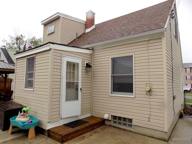 225 Fries Rd, Tonawanda-Town, NY 14150 - rear view of property featuring roof with shingles, a chimney, and a gazebo