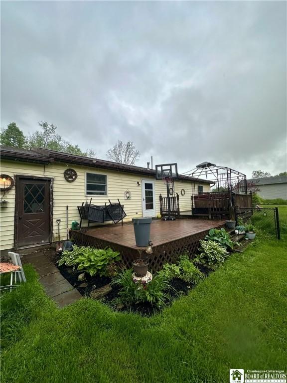 538 Erie St, Olean-City, NY 14760 - back of house with a wooden deck and a lawn