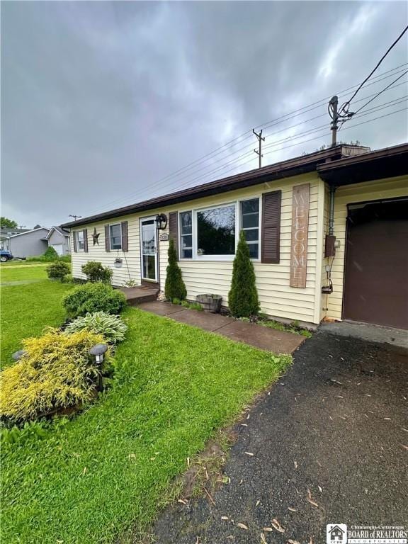 538 Erie St, Olean-City, NY 14760 - single story home featuring a front yard, asphalt driveway, and a garage