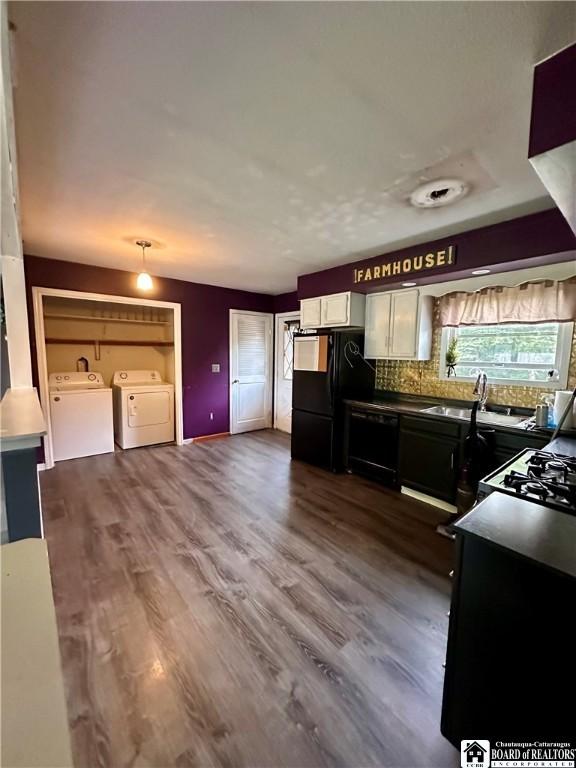 538 Erie St, Olean-City, NY 14760 - kitchen with separate washer and dryer, freestanding refrigerator, a sink, decorative backsplash, and dark wood-style flooring