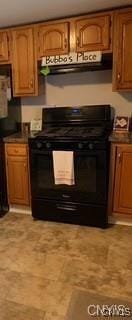 7090 Lakeshore Rd, Cicero, NY 13039 - kitchen with black gas stove, brown cabinetry, and dark countertops