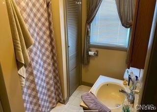 7090 Lakeshore Rd, Cicero, NY 13039 - full bathroom featuring tile patterned flooring, a shower with curtain, and baseboards