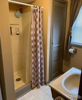 7090 Lakeshore Rd, Cicero, NY 13039 - full bath featuring a stall shower, tile patterned floors, and vanity