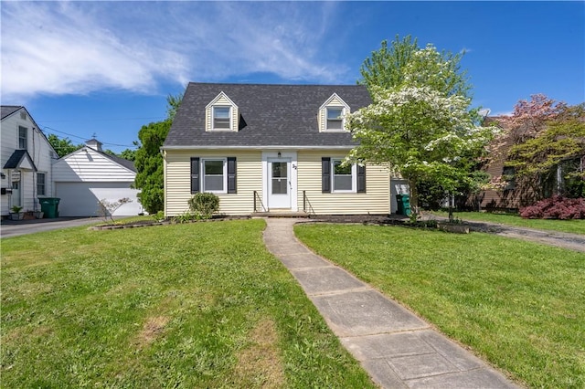 22 Idyllwood Ln, Irondequoit, NY 14617 - cape cod home featuring a front yard, a garage, an outdoor structure, and a shingled roof