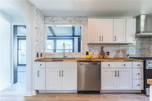 22 Idyllwood Ln, Irondequoit, NY 14617 - kitchen with appliances with stainless steel finishes, wall chimney range hood, a sink, butcher block counters, and white cabinetry