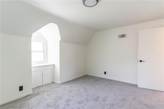 22 Idyllwood Ln, Irondequoit, NY 14617 - additional living space with light colored carpet, lofted ceiling, and baseboards