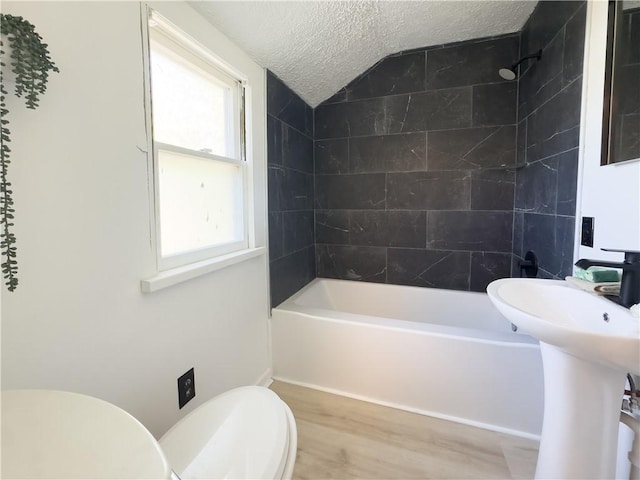 22 Idyllwood Ln, Irondequoit, NY 14617 - bathroom with toilet, wood finished floors, a textured ceiling, shower / tub combination, and vaulted ceiling