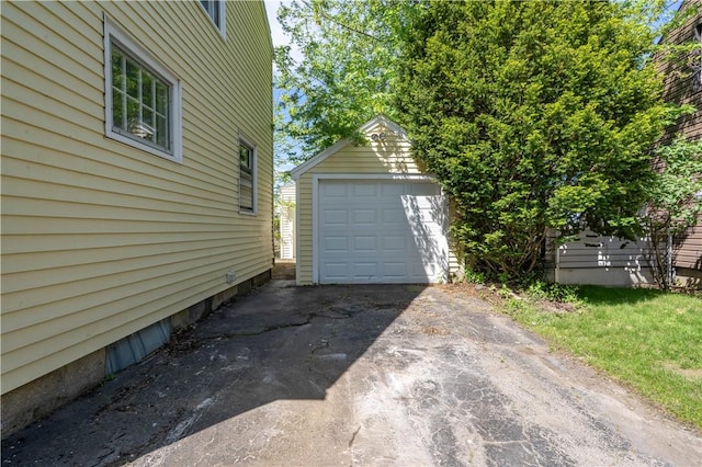 22 Idyllwood Ln, Irondequoit, NY 14617 - detached garage featuring asphalt driveway