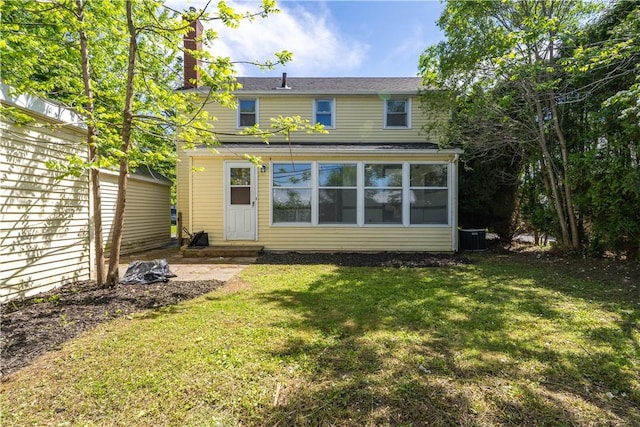 22 Idyllwood Ln, Irondequoit, NY 14617 - back of house with a lawn, a chimney, and a sunroom