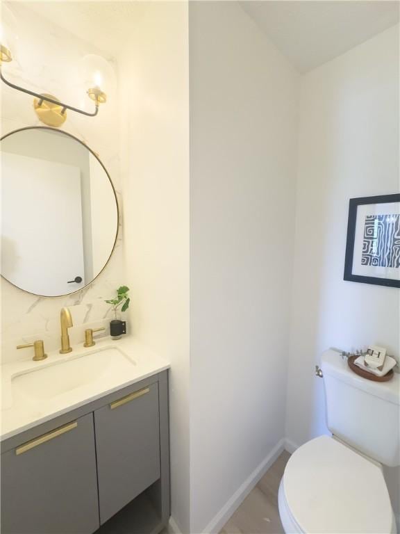 82 Haskins Ln N, Greece, NY 14468 - half bath featuring vanity, toilet, baseboards, and tasteful backsplash